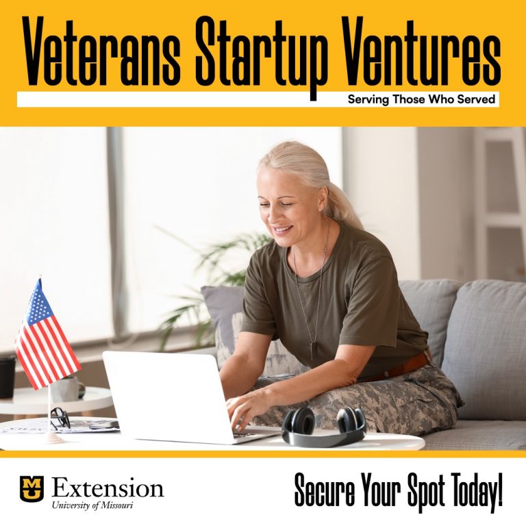 Woman in military fatigues sitting on couch working on laptop