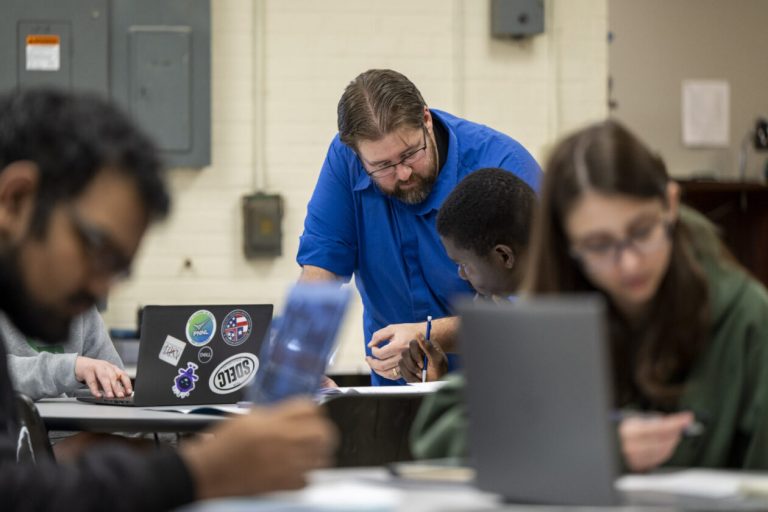 Dr. Schlegel works with students in a classroom