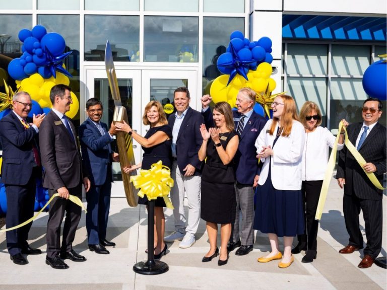 A delegation of UMKC officials, state legislators, Health Science students, and community members cut the ceremonial ribbon of the new St. Joseph Medical School Building