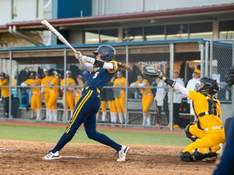 UMKC softball player hitting the ball