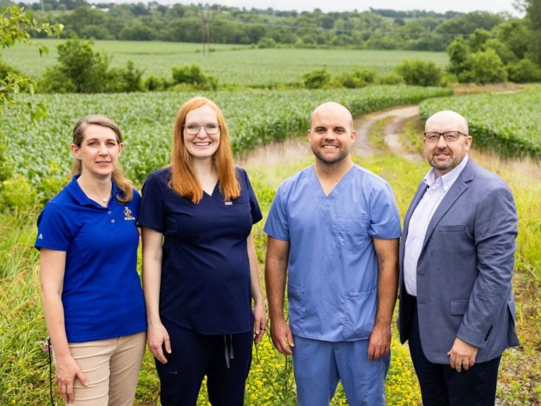 School of Medicine faculty members Kathleen Spears, Ph.D. (far left) and Mike Wacker, Ph.D. (far right) stand with medical students Mikalah Brock and Andrew Sass (Pharm.D. 