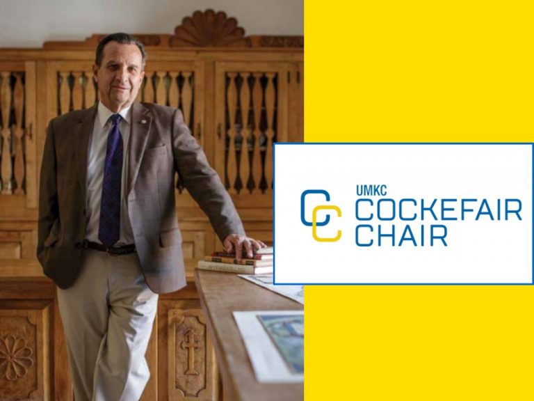 Dr. Thomas E. Chavez in front of the Cockefair Chair Logo
